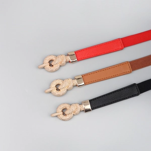 Detailed view of women's thin belts with gold knotted buckles in red, brown, and black