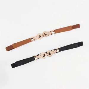 Detail view of thin elastic waist belts in brown and black with gold interlocking buckles