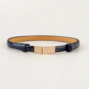 Detail view of navy blue skinny belt with glossy finish and gold rectangular buckle