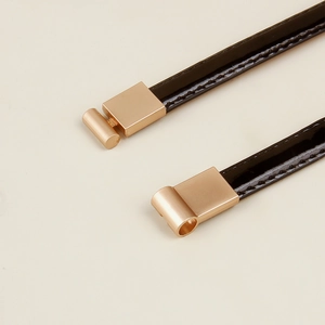 Minimalist black patent leather skinny belt for women with elegant golden metal buckle