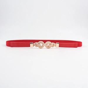 Detail of red elastic waist belt with textured golden double-ring buckle for dresses