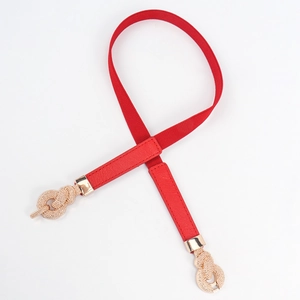 Close-up of a red elastic waist belt featuring a gold twisted knot metal buckle clasp