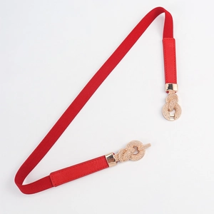Close-up of the elegant red braided elastic belt with a golden sailor knot buckle detail