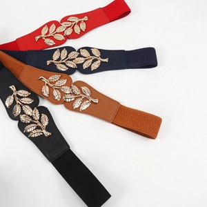 Detail of four colorful elastic leaf belts with gold metallic buckles and leaf patterns