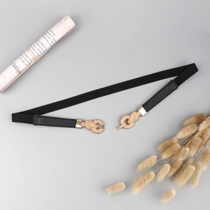 Elegant thin elastic belt for women with a golden twisted knot buckle for dresses