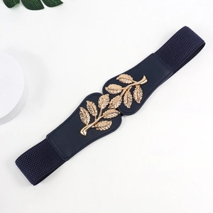 Detail of navy blue elastic waist belt with gold leaf buckle on a white pedestal