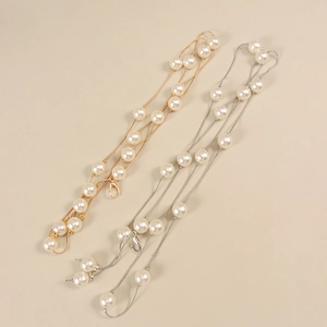 Détail de chaînes de taille élégantes en perles or et argent avec fermoir mousqueton