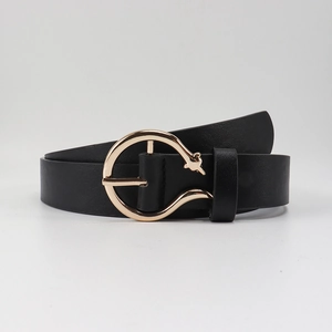 Close-up of minimalist black leather belt with golden round buckle and star ornament