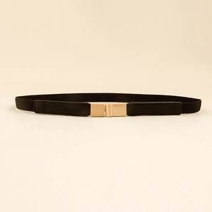 Close-up of the gold rectangular metal buckle and elastic black waist belt material