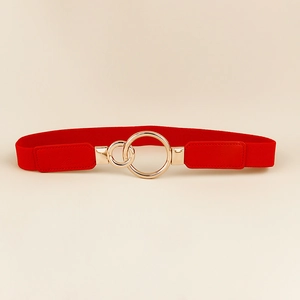 Detail of red elastic waist belt featuring a polished gold interlocking double ring buckle