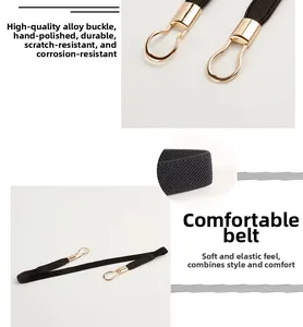 Detail of slim black elastic belt with golden alloy buckle and premium metal texture