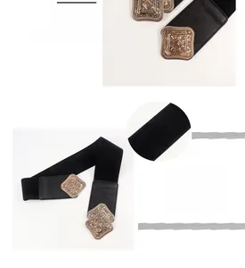 Detail of vintage engraved alloy buckle on wide elastic corset belt for dresses