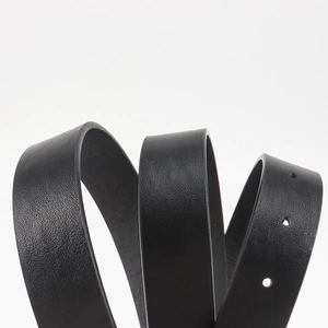 Macro shot of high-quality black leather belt showing natural texture and neat adjustment holes