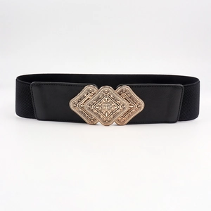 Close-up of vintage golden rhombus buckle with hollow patterns on black elastic waist belt