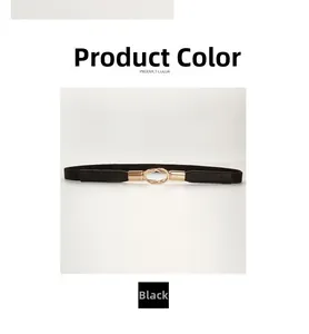 Detail of slim black elastic waist belt featuring a polished golden double ring buckle