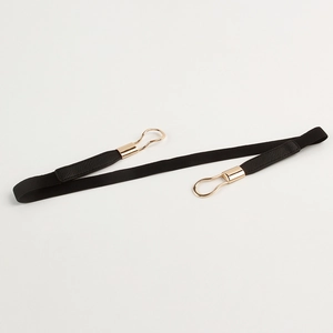 Close-up of black elastic waist belt with elegant gold metal double ring buckle detail
