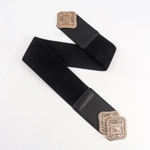 Detail of vintage bronze buckles and black elastic band on a medieval style corset belt