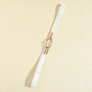 Detail view of white elastic waist belt with elegant gold double ring buckle closure
