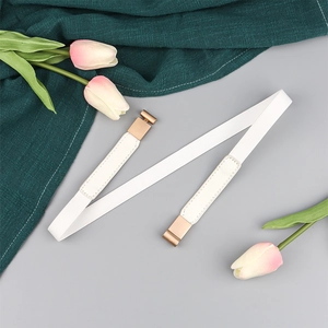 Close-up of a white elastic waist belt with a gold metal buckle and tulip decoration