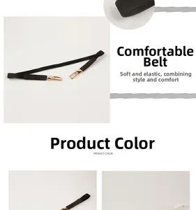Detail von flexiblen Damen-Elastikgürteln mit goldener Schnalle in Schwarz und Weiß