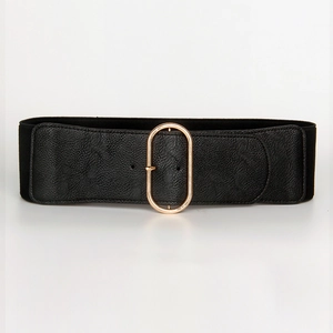 Close-up of golden oval buckle on black wide elastic waist belt with lychee texture