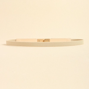 Close-up of elegant beige elastic belt with a minimalist light gold square metal buckle