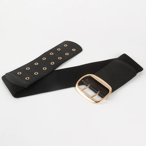 Detail of wide black elastic corset belt with large gold buckle and metal eyelets