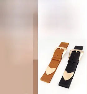 Detail view of elastic waist belt with large gold alloy buckle in black and brown
