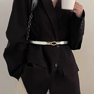 Slim white leather waist belt with gold oval buckle on black blazer for women