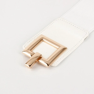 Detail of white elastic waist belt featuring a polished gold square metal buckle