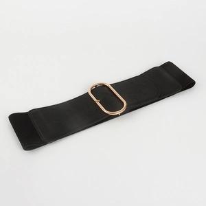 Close-up of black wide elastic waist belt featuring a polished gold oval metal buckle