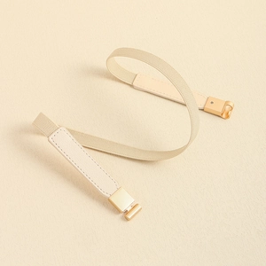 Detail view of beige elastic thin waist belt featuring gold square buckle and fine stitching