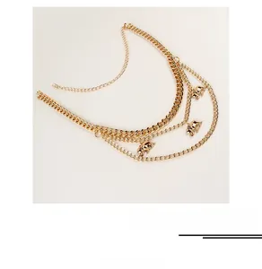 Detailed view of golden multi-layer waist chain with elephant pendants and lobster clasp