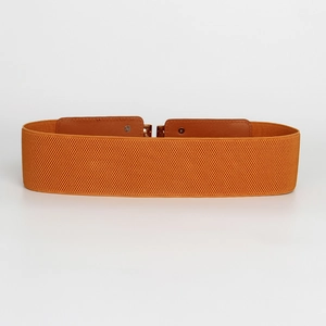 Detail of orange elastic wide waist belt with brown faux leather patch and metal buckle