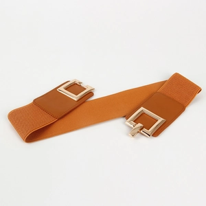 Close-up of amber orange wide elastic belt with gold square metal buckle and leather ends