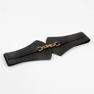 Detail of black elastic waist belt featuring a decorative gold-tone metal buckle