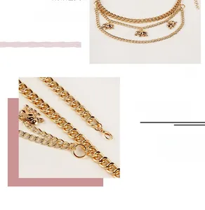 Detail view of multi-layer golden waist chain with small elephant charms and lobster clasp