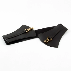 Close-up of black corset belt with gold metal shackle buckle and scalloped leather panels