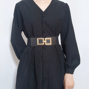 Elastic black waist belt with gold square buckle on dress for women styling