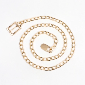 Detail of bright gold metal chain belt with a sleek rectangular buckle on white background