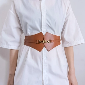Brown wide corset belt with gold interlocking buckle on a white button-down shirt