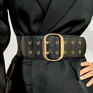 Chic black wide leather belt with oval gold buckle and metallic eyelets for coats