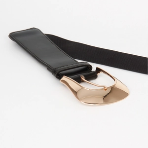 Detailed close-up of a high-elastic black belt featuring a large polished gold metal buckle