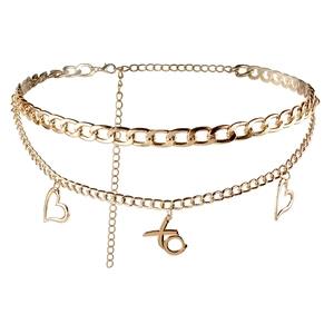 Detail of gold multilayer waist chain with heart charms and XO pendant for jeans
