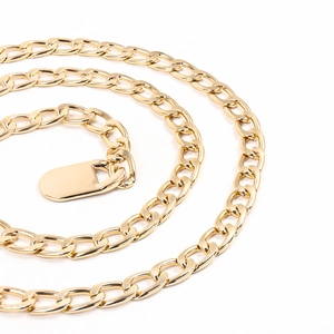 Detailed view of chunky golden metal waist chain featuring flat oval links and a smooth tag