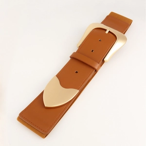 Detail view of camel elastic waist belt featuring a large gold buckle and leather texture