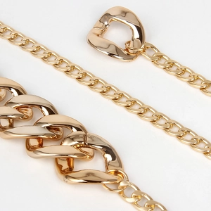 Golden chunky metal chain belt with high-gloss wavy links and irregular D-ring buckle