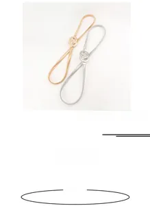 Detail view of 70cm metal elastic waist belts in gold and silver with double ring buckles