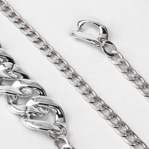Close-up of dual-layered silver acrylic waist chain with thick and fine curb link details