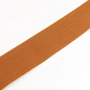Close-up of caramel elastic belt showing the fine woven texture and flexible material